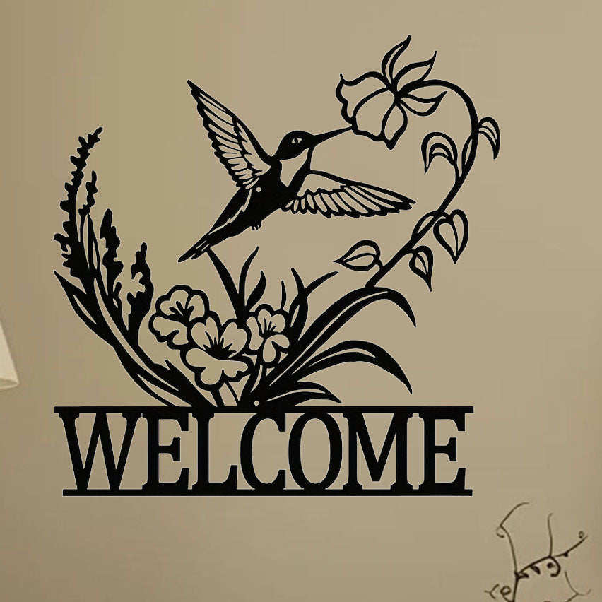 Hummingbird metal welcome sign mounted on a wall